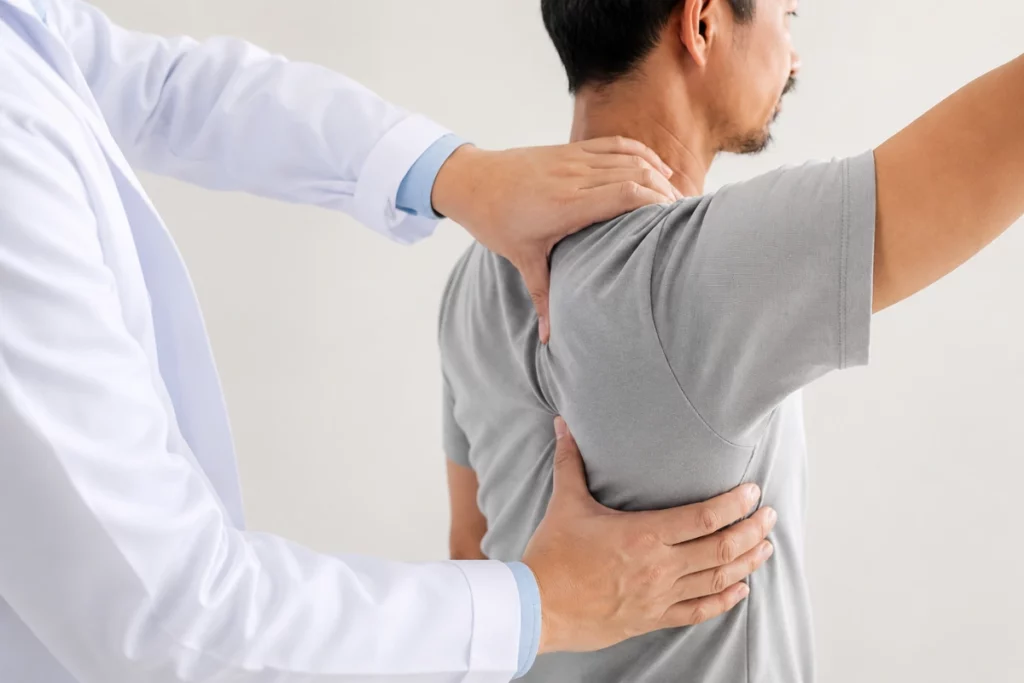 Doctor examining a patient for rotator cuff tear and shoulder pain
